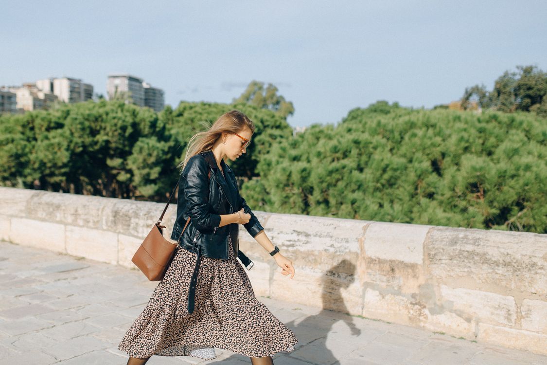 A Woman Wearing a Leather Jacket over a Dress Walking Free Stock Photo A Woman Wearing a Leather Jacket over a Dress Walking Free Stock Photo