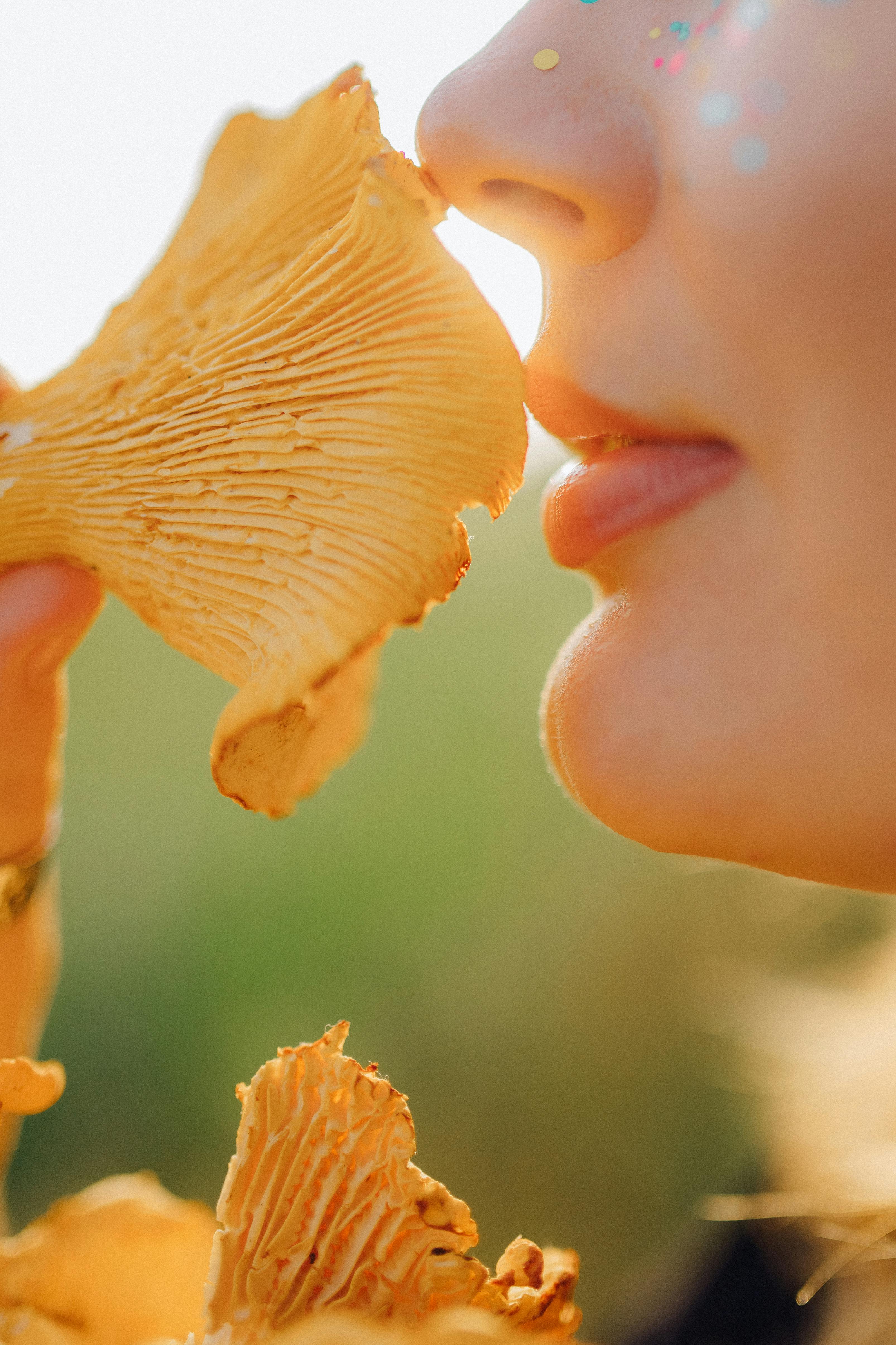 woman holding a brown mushroom