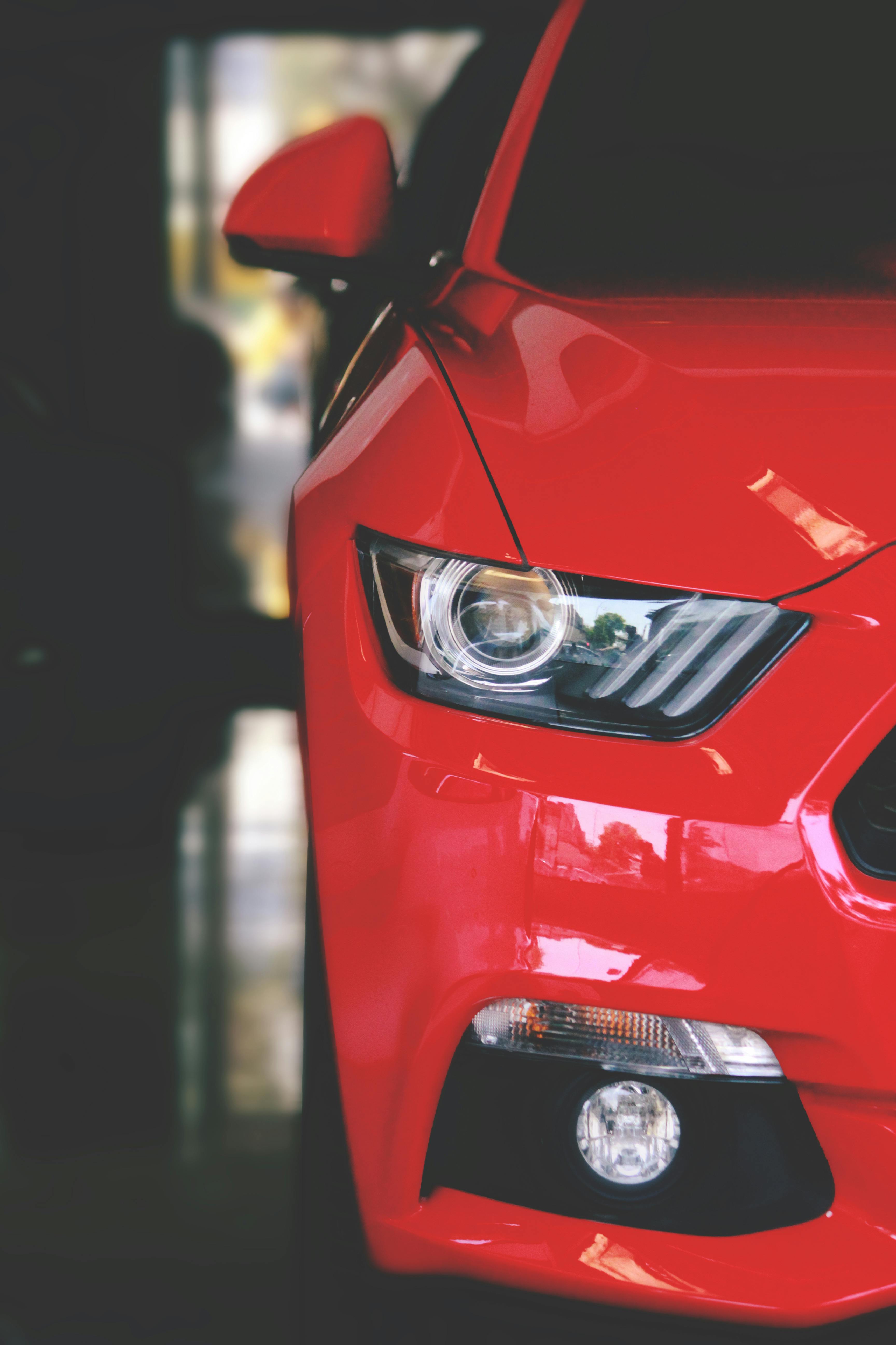 red car parked on pavement