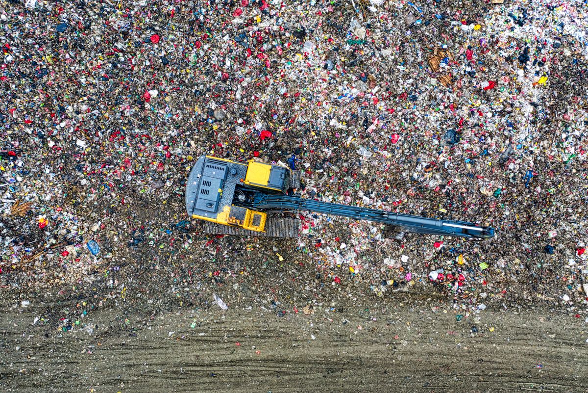 Machinery working the face of a landfill, photo by Tom Fisk on Pexels