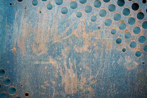 Textured background of grunge metal wall with holes