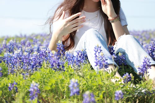 Woman Sitting on a Meadow with Bluebonnets 