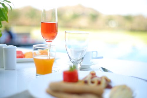 Free Fresh orange juice and glass with colorful drink near plate with delicious pizza in cafe Stock Photo