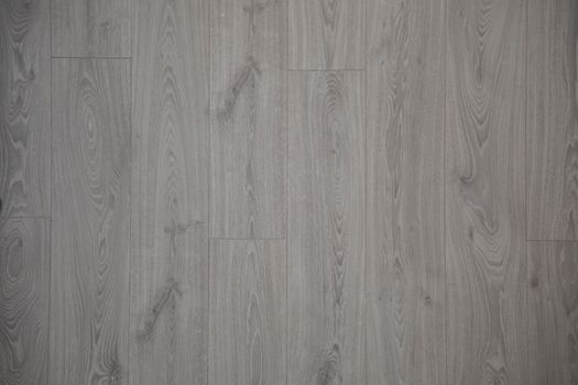Close-up view of gray wooden floor planks with natural texture and pattern.