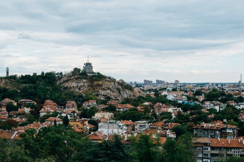 Free Aerial view of Plovdiv, Bulgaria showcases its hills and architecture under a cloudy sky. Stock Photo