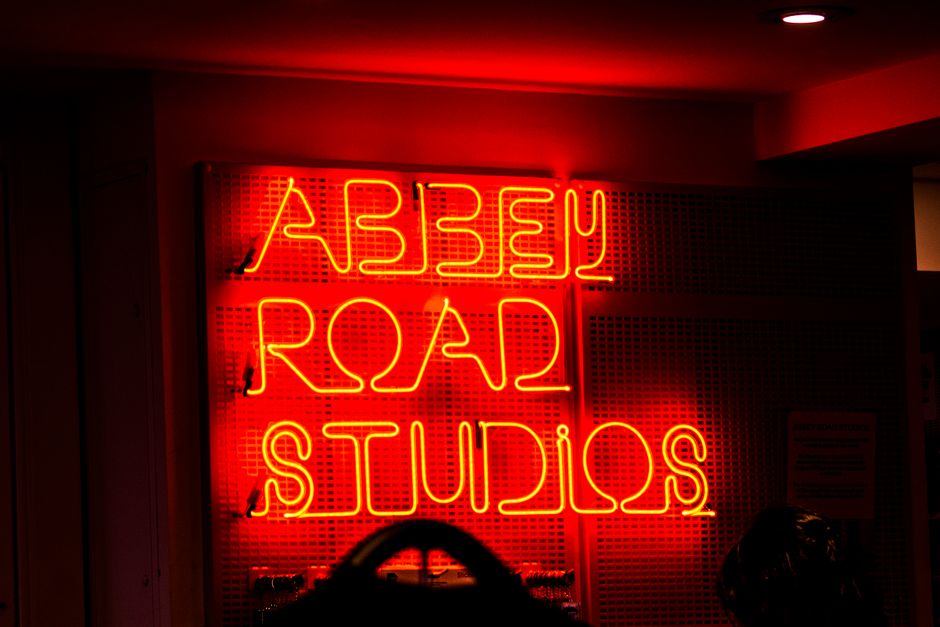 Vibrant neon sign of Abbey Road Studios, an iconic music recording location.