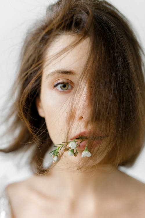 A Woman Covering Hair on Face