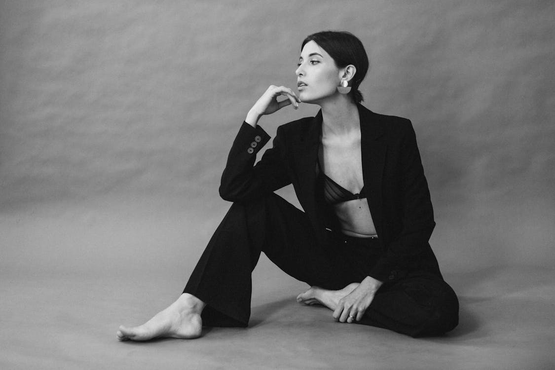 Free Elegant black-and-white studio portrait of a woman in modern fashion. Stock Photo