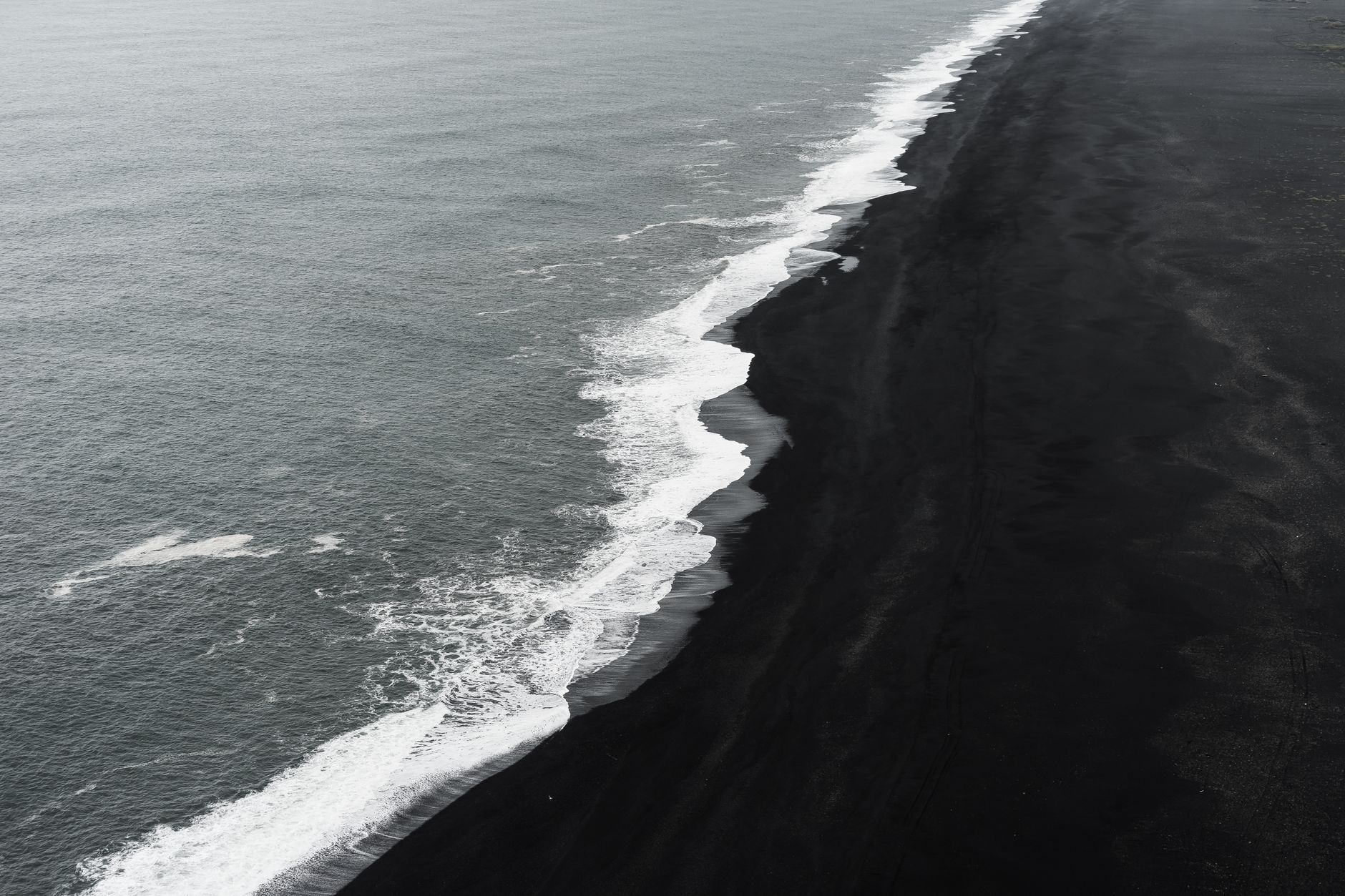 A breathtaking aerial shot of Iceland's unique black sand beach contrasting with the ocean waves.. pexels, breathtaking, aeri