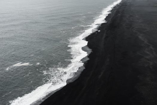 A breathtaking aerial shot of Iceland's unique black sand beach contrasting with the ocean waves.. pexels, breathtaking, aeri