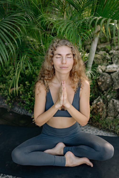 A Woman Meditating With Her Eyes Closed 