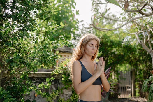 Peaceful woman practicing yoga and mindfulness in a lush, green outdoor garden.
