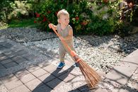 Girl in Brown Tank Top and Blue Denim Jeans Holding Broom