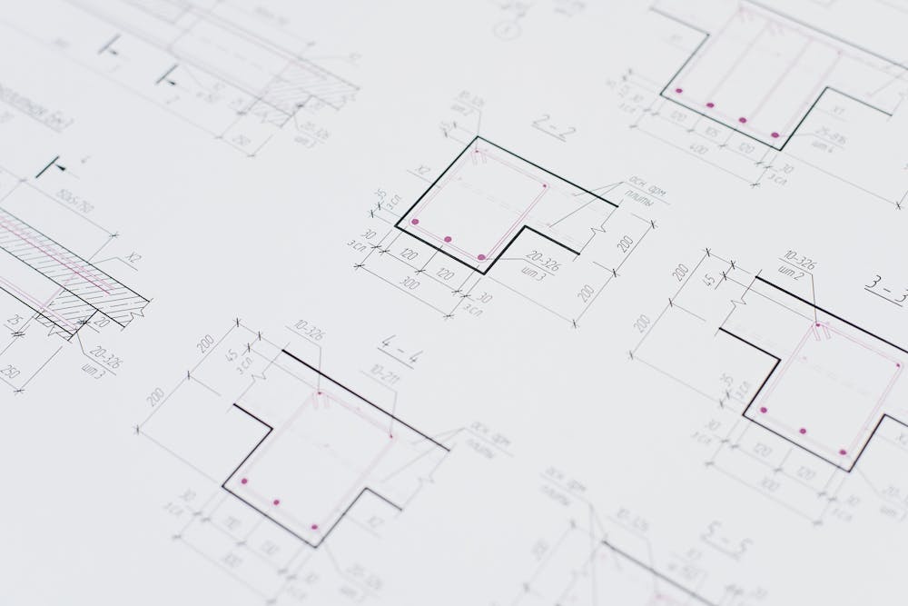 High-resolution close-up of detailed architectural blueprints showcasing precision design layouts.