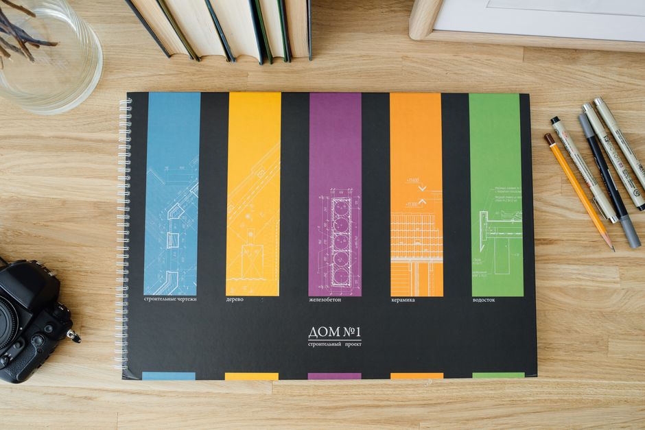 Photo by Ivan S on Pexels Design and architecture workbook with colorful blueprints on a wooden desk. - Photo by Ivan S on Pexels