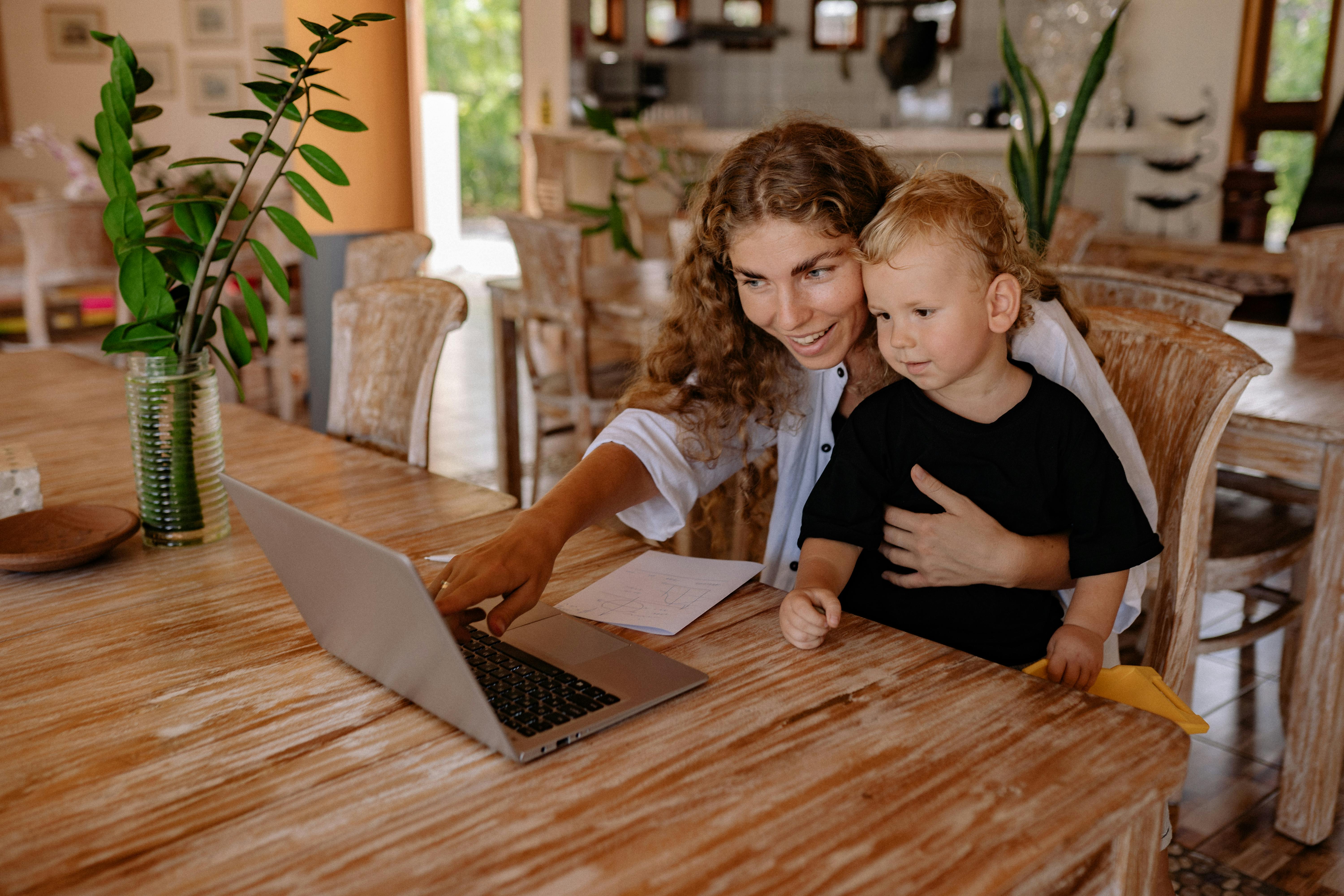 mom and son looking at the laptop