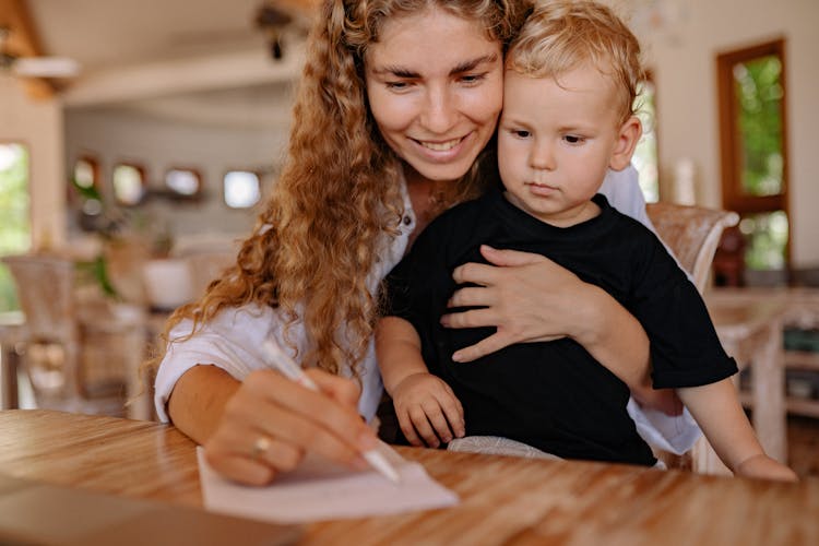 A Woman Holding A Young Boy 