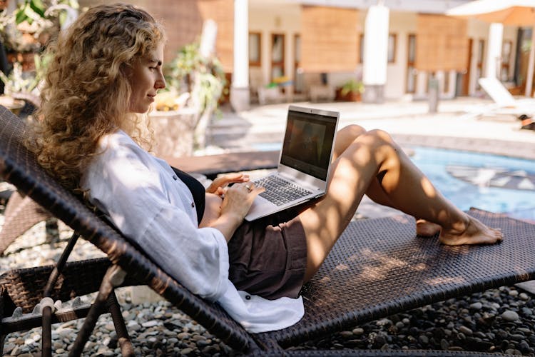 Side View Of A Woman Using Laptop