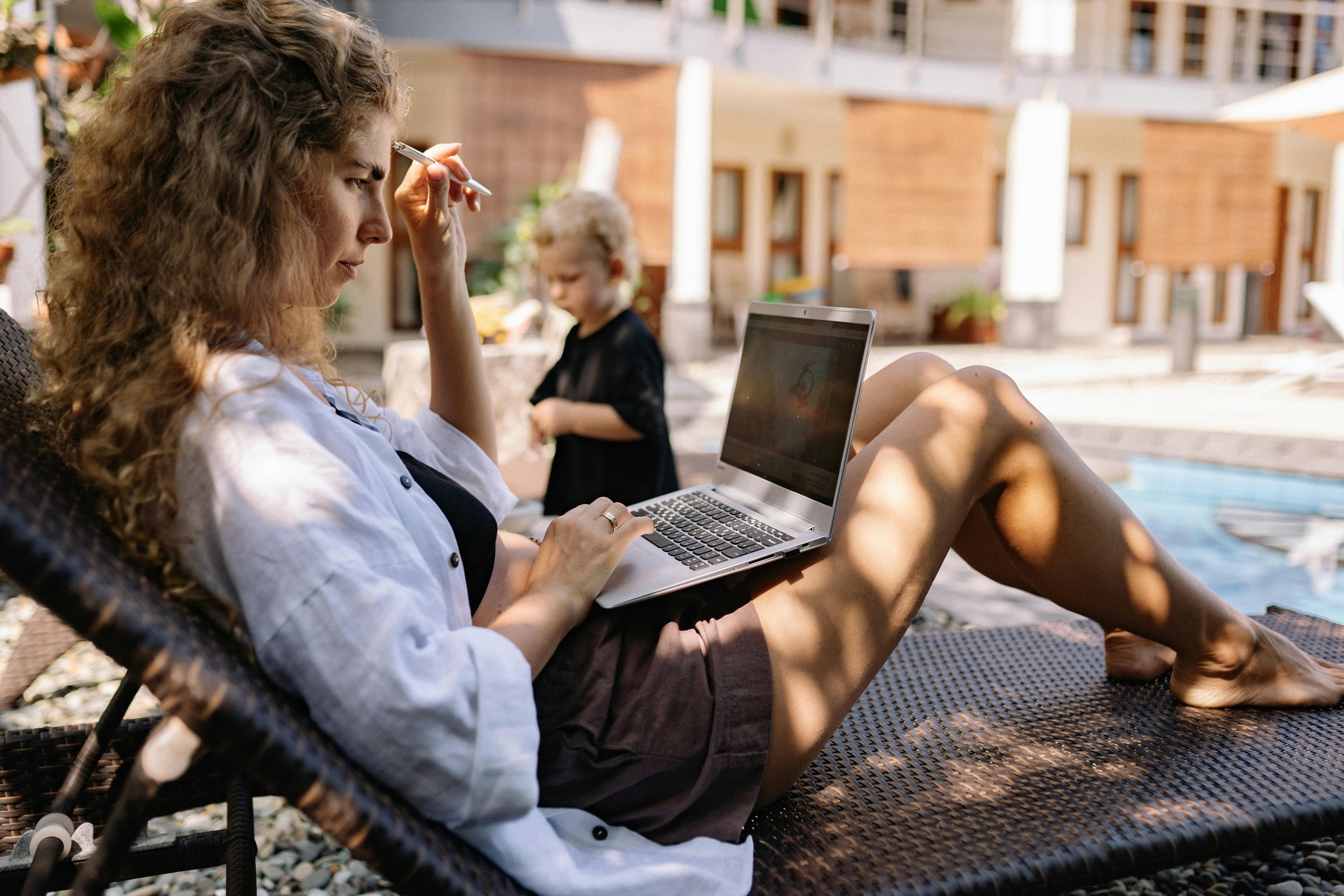 a woman with curly hair while using laptop