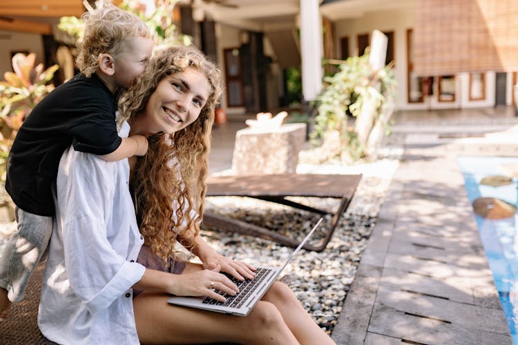 Woman With Curly Hair With Her Baby 