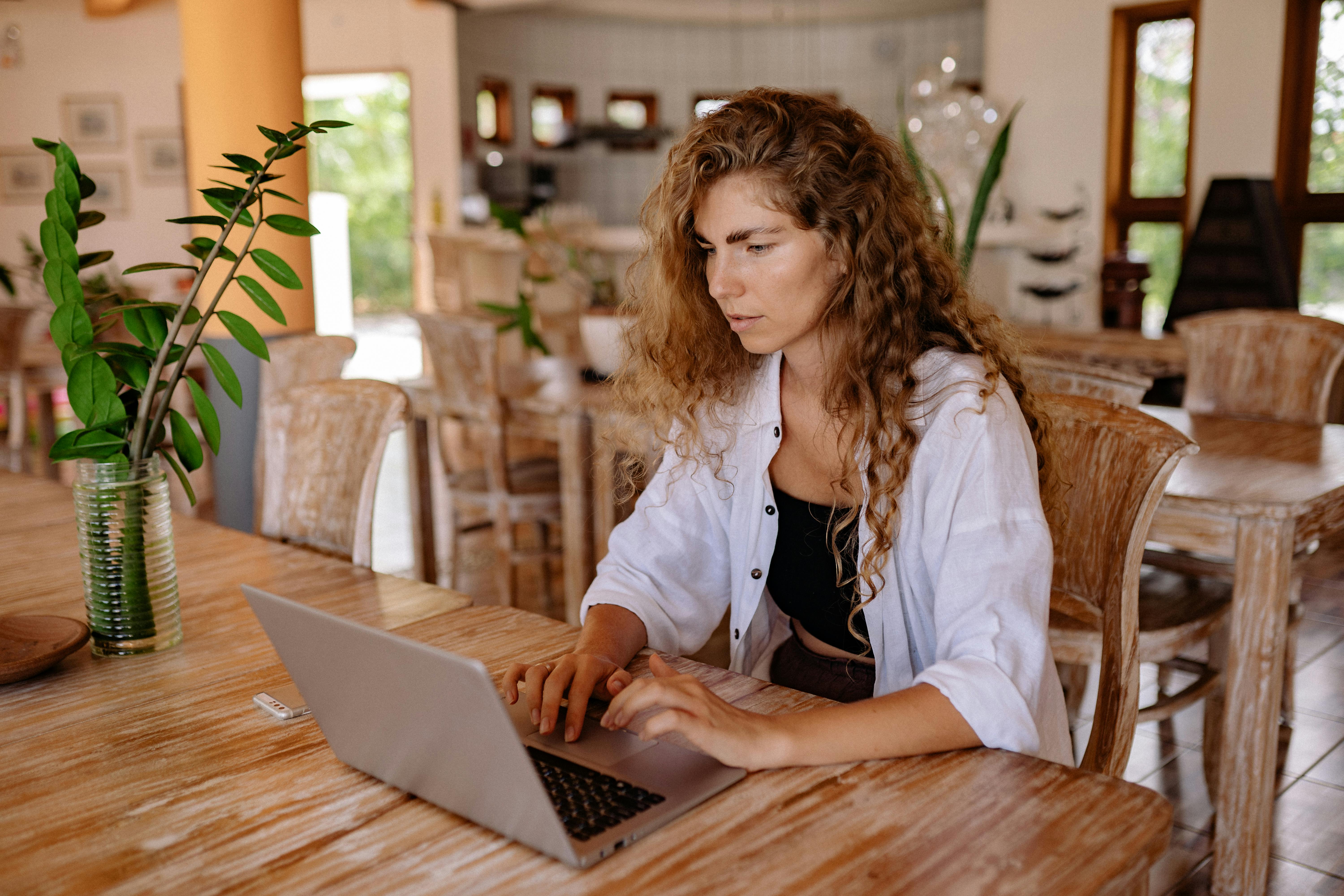 young woman using laptop at vintage cafe