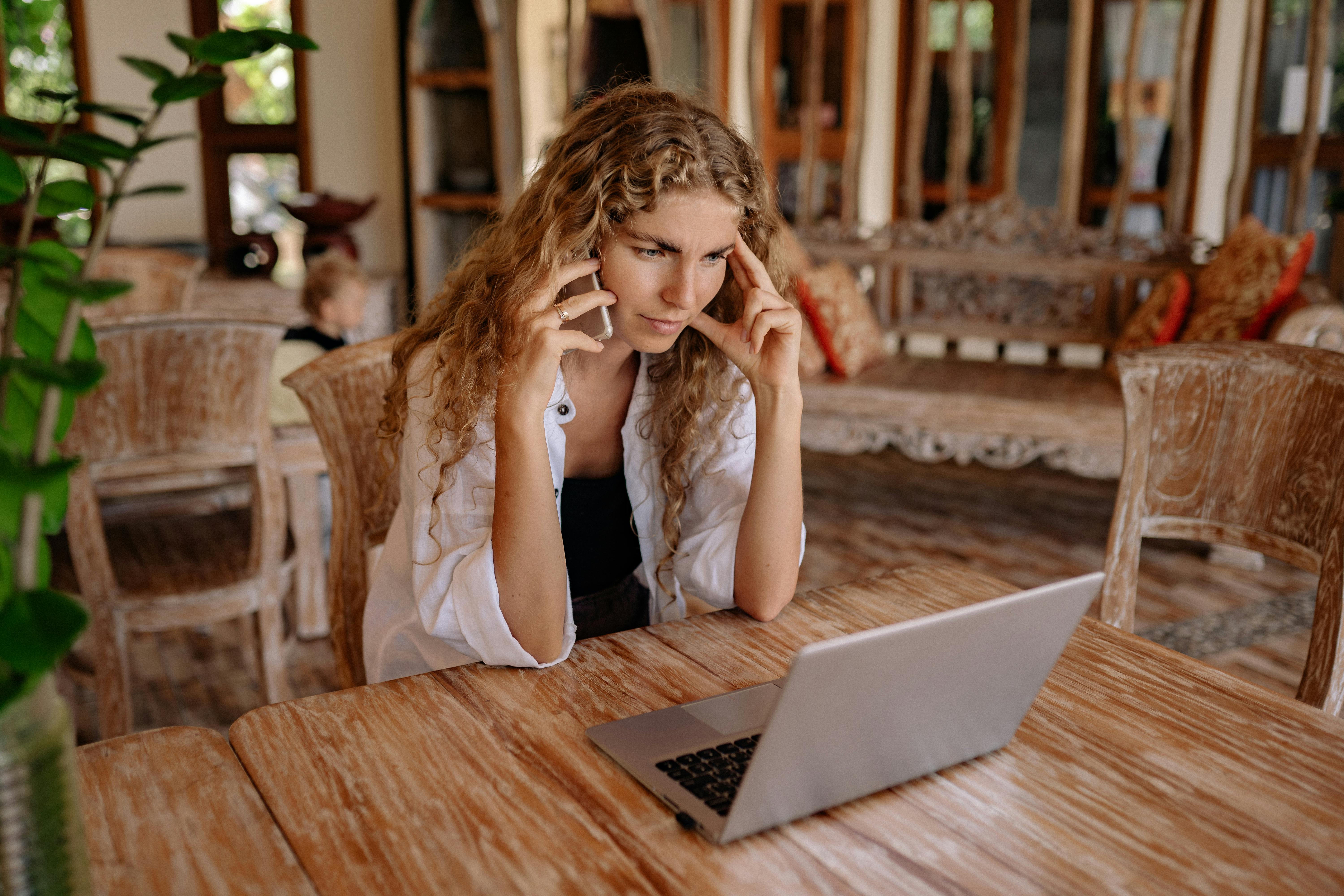 photo of woman using cellphone while looking serious