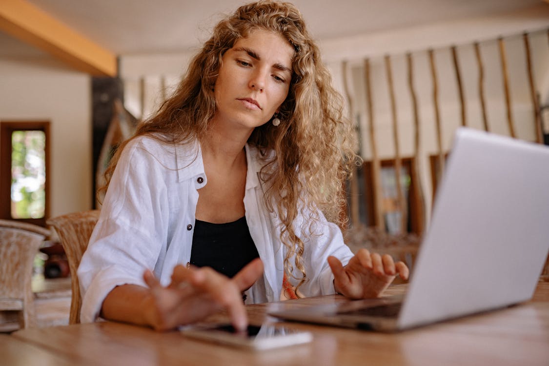 Free Woman in White Blazer Using Macbook Pro Stock Photo