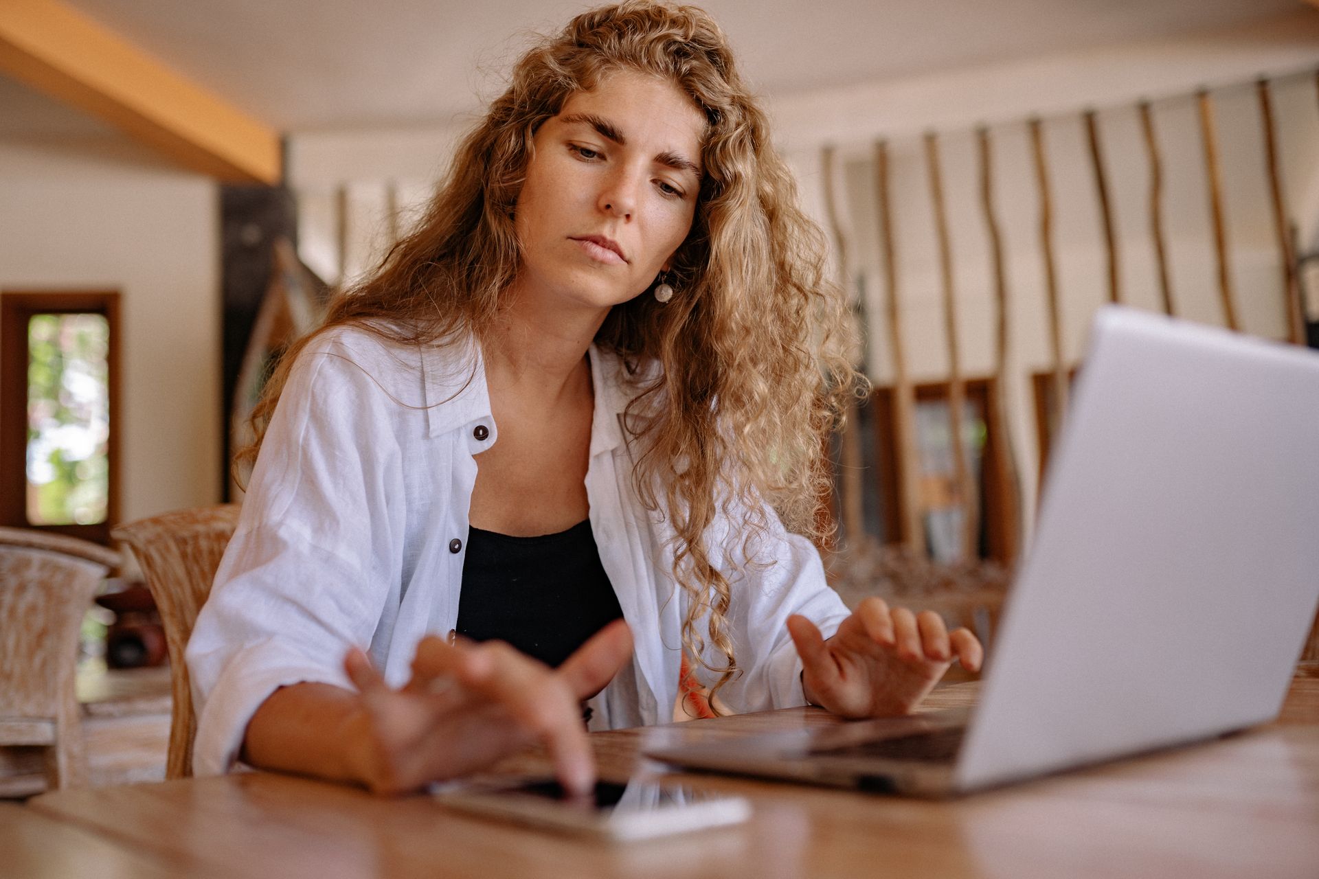 Woman in White Blazer Using Macbook Pro