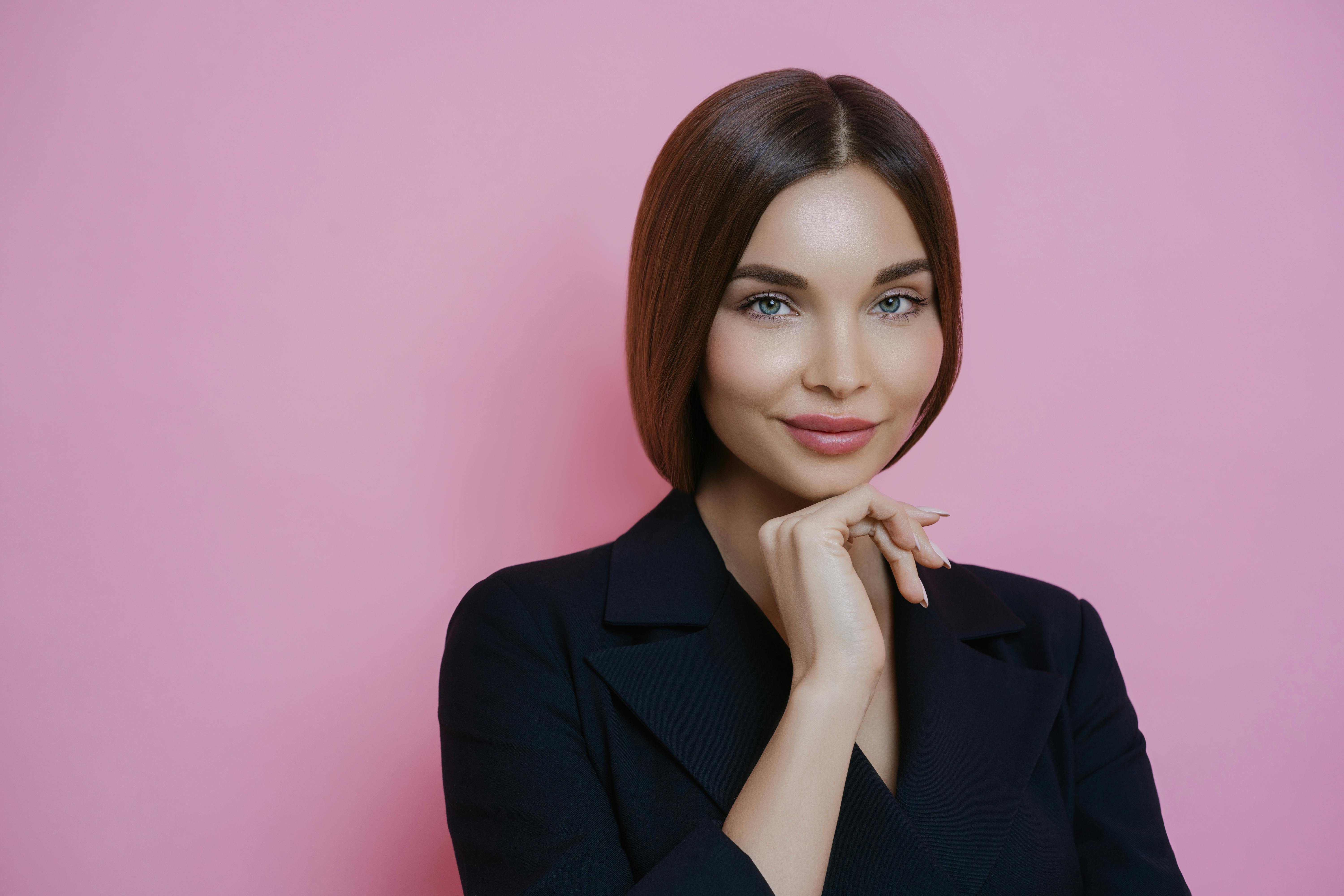 positive woman near pink wall