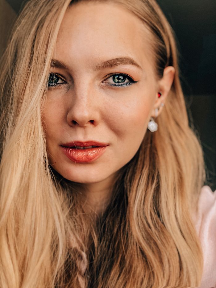 Close portrait of a blonde woman with elegant evening makeup and earrings