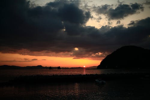 Cloudy sunset over calm sea water