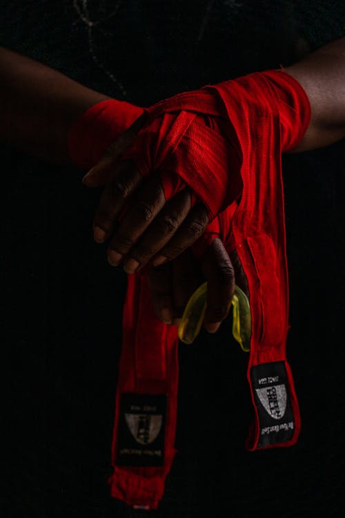 A Person Wearing Red Hand Wraps