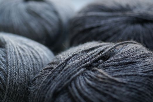 Skeins of gray woolen yarn on table