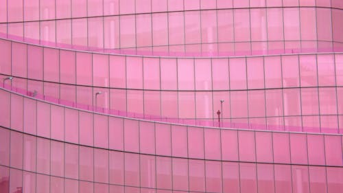Pink glass skyscraper facade in modern city
