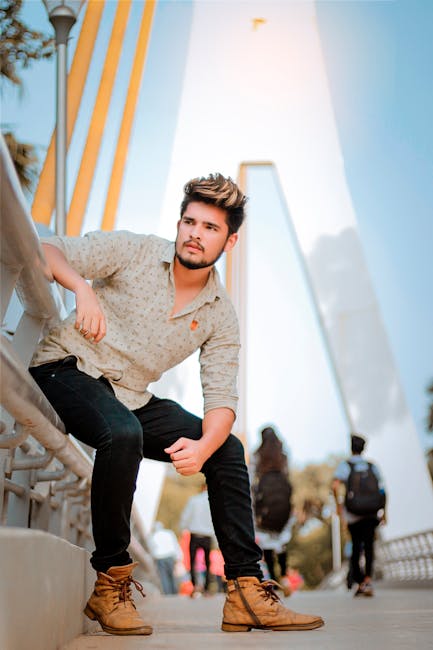 Fashionable man posing confidently on a modern bridge in Vadodara, India.