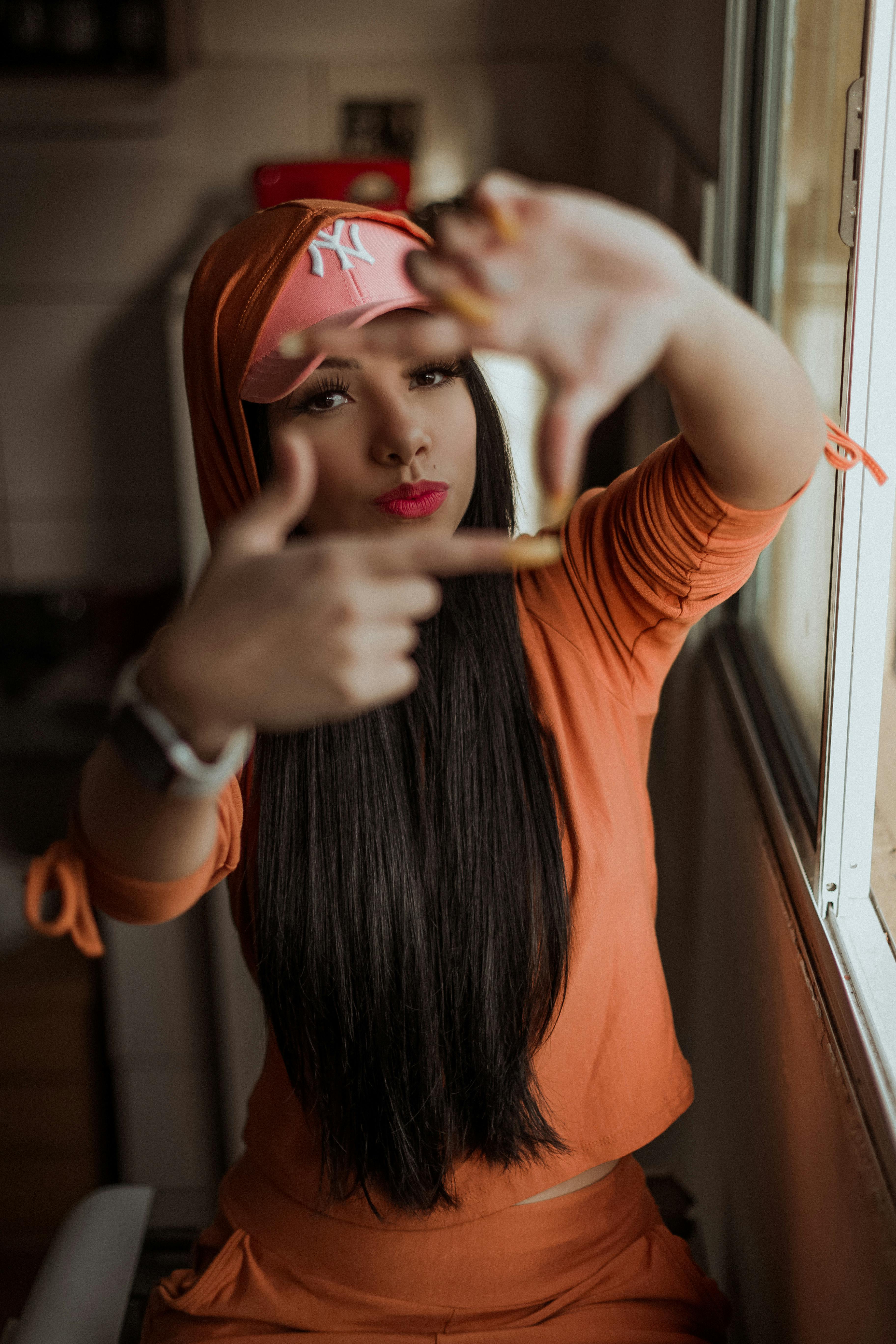 trendy young ethnic brunette making frame with fingers