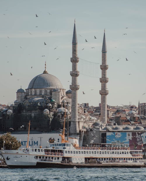 Historical mosque at waterfront on sunny day