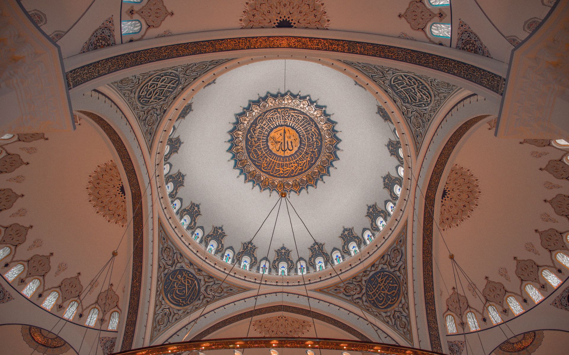 From below of ornamental dome with golden geometrical traditional elements and cultural Arabic decorations in ancient Islam building in Eastern style