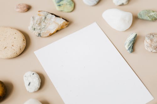 A White Paper Surrounded with Stones