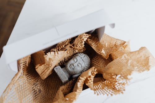 Granite Buddha bust in cardboard package