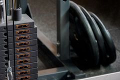 Detailed view of a gym machine's weight stack and weight plates, ideal for fitness-themed visuals.