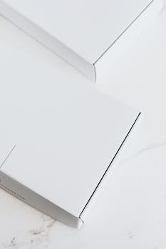 A sleek white box resting on a clean marble surface, perfect for product presentations.