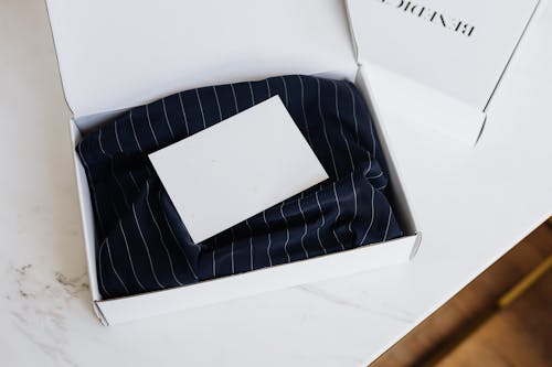Branded Clothes Packed in White Cardboard Box 