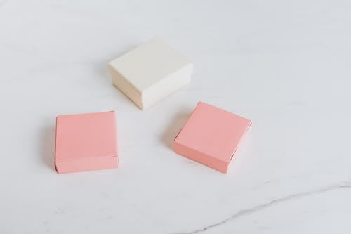 Pink and White Boxes on a White Surface