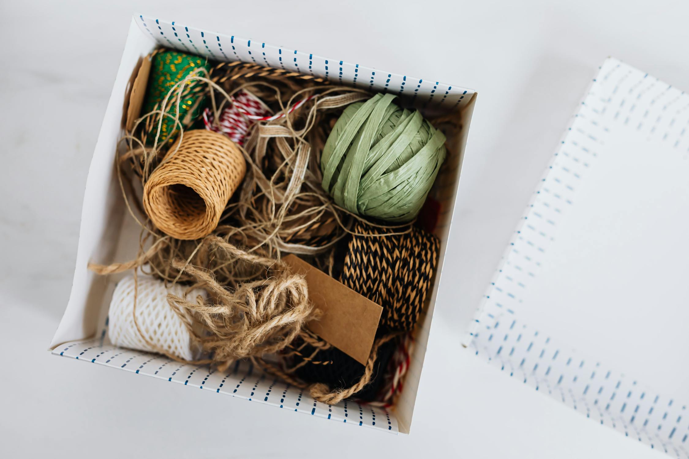 Various ribbons and ropes for packages wrapping in box · Free Stock Photo