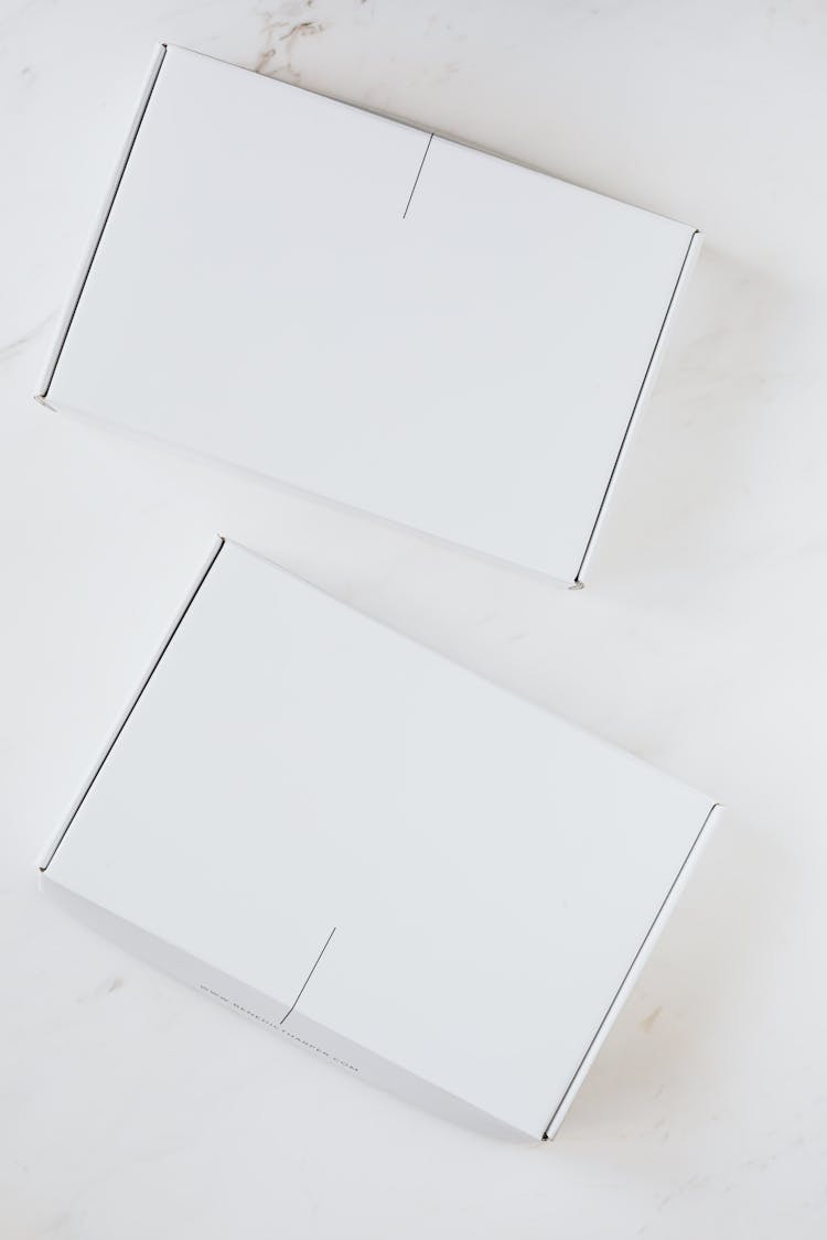 Two Boxes On A White Surface