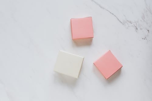 Pink and White Boxes on a White Surface