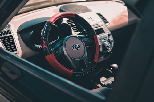 From above of contemporary design car interior with colorful steering wheel and radio with buttons