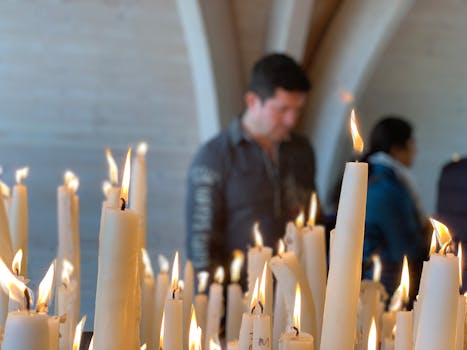Candles burning inside a church in Lourdes, emphasizing spirituality and peace.