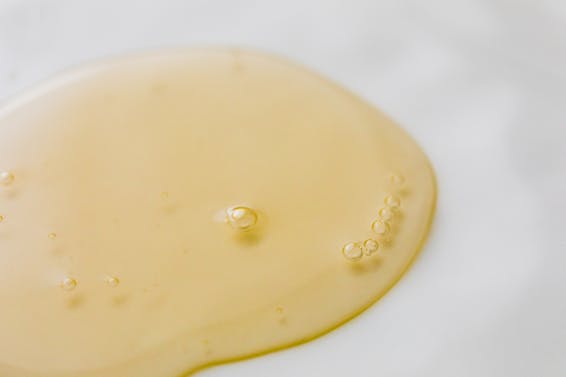 Transparent yellowish liquid on white surface